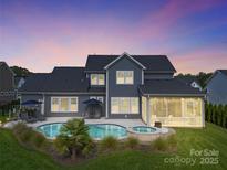 Stunning home with pool and landscaped yard at dusk at 11112 Benjamin Smith Ave, Huntersville, NC 28078
