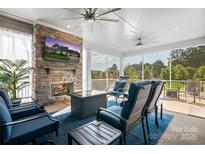 Cozy screened porch with fireplace and comfortable seating at 11112 Benjamin Smith Ave, Huntersville, NC 28078
