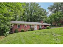 Charming brick home featuring a lush green lawn and inviting curb appeal at 132 30Th Nw Ave, Hickory, NC 28601