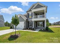 Charming two-story home with inviting front porch and landscaped yard at 2024 Embassy Ct # 49, Charlotte, NC 28213
