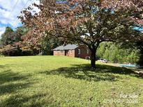 Brick ranch home with a large yard and inground pool at 6200 George Hildebran School Rd, Hickory, NC 28602