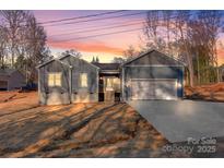 Newly constructed home with gray siding, two-car garage, and landscaped yard at 9181 Cherokee Dr, Hickory, NC 28601