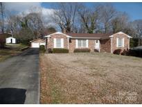 Brick ranch home with attached garage and spacious yard at 211 Walnut Ave, Mount Holly, NC 28120