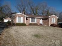 Brick ranch home with attached garage and spacious yard at 211 Walnut Ave, Mount Holly, NC 28120