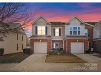 Brick front two-story townhome with attached garage and landscaping at 2430 Kensington Station Pkwy, Charlotte, NC 28210