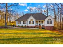 White house with brick accents, large yard, and mature trees at 2740 Hill Top Dr, Salisbury, NC 28147