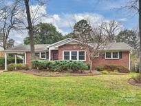 Brick ranch home with carport and landscaped lawn at 3624 Trent St, Charlotte, NC 28209