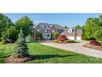 Stunning brick home with lush landscaping, circular driveway, and attached three-car garage at 4165 54Th Ne Ave, Hickory, NC 28601