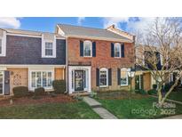 Brick front townhouse with a charming, landscaped yard at 4413 Simsbury Rd, Charlotte, NC 28226