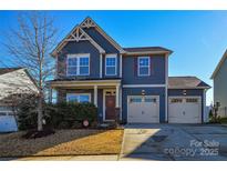 Two-story home with gray siding, two-car garage, and landscaping at 4418 Huntley Glen Dr, Pineville, NC 28134