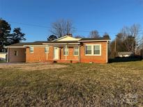 Brick ranch home with covered porch and large yard at 648 Scotts Creek Rd, Statesville, NC 28625