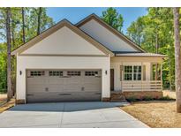 Craftsman style home with gray garage door and front porch at 936 Jackson Rd, Fort Lawn, SC 29714