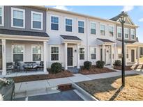 Three-unit townhome building, light gray exterior, front porches, landscaping at 13883 Clayborn St, Midland, NC 28107