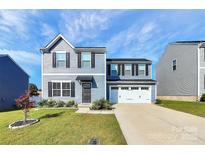 Two-story home with gray siding and a two-car garage at 153 Crownpiece St, Troutman, NC 28166