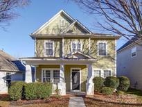 Two-story house with green siding, white columns, and landscaping at 18618 The Commons Blvd, Cornelius, NC 28031