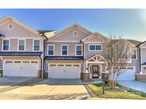 Modern 2-story townhome with gray siding, attached garage, and landscaped lawn at 373 Battery Cir, Clover, SC 29710