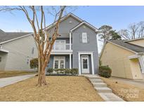 Two-story gray house with a balcony, steps, and landscaping at 4827 Eaves Ln, Charlotte, NC 28215