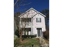 Charming two-story home with gray door and small balcony at 4827 Eaves Ln, Charlotte, NC 28215