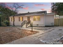 Charming renovated home with a white brick exterior, landscaping, and a spacious driveway at 5113 Grice Ct, Charlotte, NC 28210