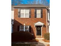 Brick front exterior of charming townhome with landscaping at 8044 Sapwood Ct, Matthews, NC 28104