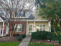 Brick and siding townhouse exterior with a covered entryway and landscaped yard at 8146 Rudolph Rd, Charlotte, NC 28216