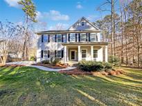 Two-story house with gray siding, a covered porch, and a landscaped lawn at 14916 Oregon Oak Ct, Mint Hill, NC 28227