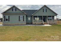 Charming home featuring a covered porch, complemented by dark shutters and a well-manicured lawn at 226 Beths Ct, York, SC 29745