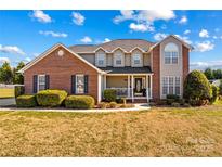 Brick two-story house with a large front yard and landscaping at 415 Cameron Dr, Salisbury, NC 28147