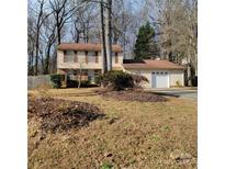 Two-story house with attached garage and basketball hoop at 6619 Wagon Oak Rd, Charlotte, NC 28212