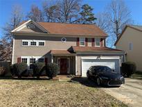 Two-story house with brown siding, red shutters, and a two-car garage at 9624 Langston Mill Rd, Charlotte, NC 28216