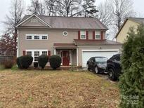 Two-story house with a neutral exterior, attached garage, and well-maintained lawn at 9624 Langston Mill Rd, Charlotte, NC 28216