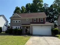 Charming two-story home with a well-maintained lawn, inviting entrance, and attached two-car garage at 9624 Langston Mill Rd, Charlotte, NC 28216