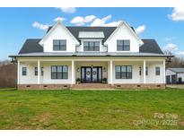 Two-story farmhouse with large front porch and attached garage at 1026 Walker Branch Rd, Lincolnton, NC 28092