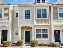 Two-story townhome with neutral siding and a black front door at 13441 Calloway Glen Dr, Charlotte, NC 28273