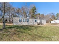 Charming single-story home with gray siding, black shutters and front yard at 1805 Drew Dr, Lincolnton, NC 28092