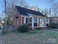 Brick house with a large yard and a small deck at 2101 Russell Ave, Charlotte, NC 28216