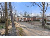 Brick ranch home with a carport and mature trees at 234 Robinson St, Rock Hill, SC 29730