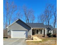 Gray house with white garage door and stone accents at 34466 Lisa Dr, Albemarle, NC 28001