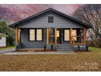 Charming gray house with wood accents and landscaped yard at 4421 Gum St, Charlotte, NC 28208