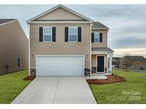 Charming two-story home with a two-car garage and a well-maintained front lawn at 5063 Beargrass Dr, Dallas, NC 28034