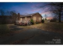 Brick ranch house with a deck, situated on a spacious lot at 7392 Reeps Grove Church Rd, Vale, NC 28168