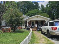 House exterior with a yard, white picket fence, and driveway at 800 Thera Dr, Charlotte, NC 28206