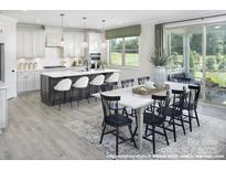 Bright kitchen with island, stainless steel appliances, and eat-in area at 9957 Cask Way, Huntersville, NC 28078