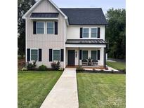 Two-story house with gray and white siding, black shutters, and a covered porch at 114 E 5Th Ave # 6, Gastonia, NC 28052