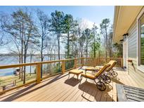 Lakefront deck with wooden floor and comfortable seating at 1221 Brunson Rd, Fort Lawn, SC 29714