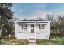 Charming white bungalow with front porch and steps at 203 Linwood Rd, Kings Mountain, NC 28086