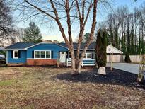 Charming ranch home with blue siding, brick accents, and a landscaped lawn at 235 Linda St, Salisbury, NC 28146