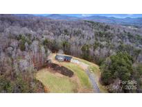 Ranch home nestled in scenic mountains with expansive wooded acreage at 277 Archie Mountain Ln, Taylorsville, NC 28681