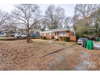 Brick ranch home with mature trees and a spacious yard at 4405 Tillman Rd, Charlotte, NC 28208