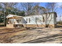 Ranch-style home with covered porch and ample parking at 7933 Cherry Point Dr, Denver, NC 28037